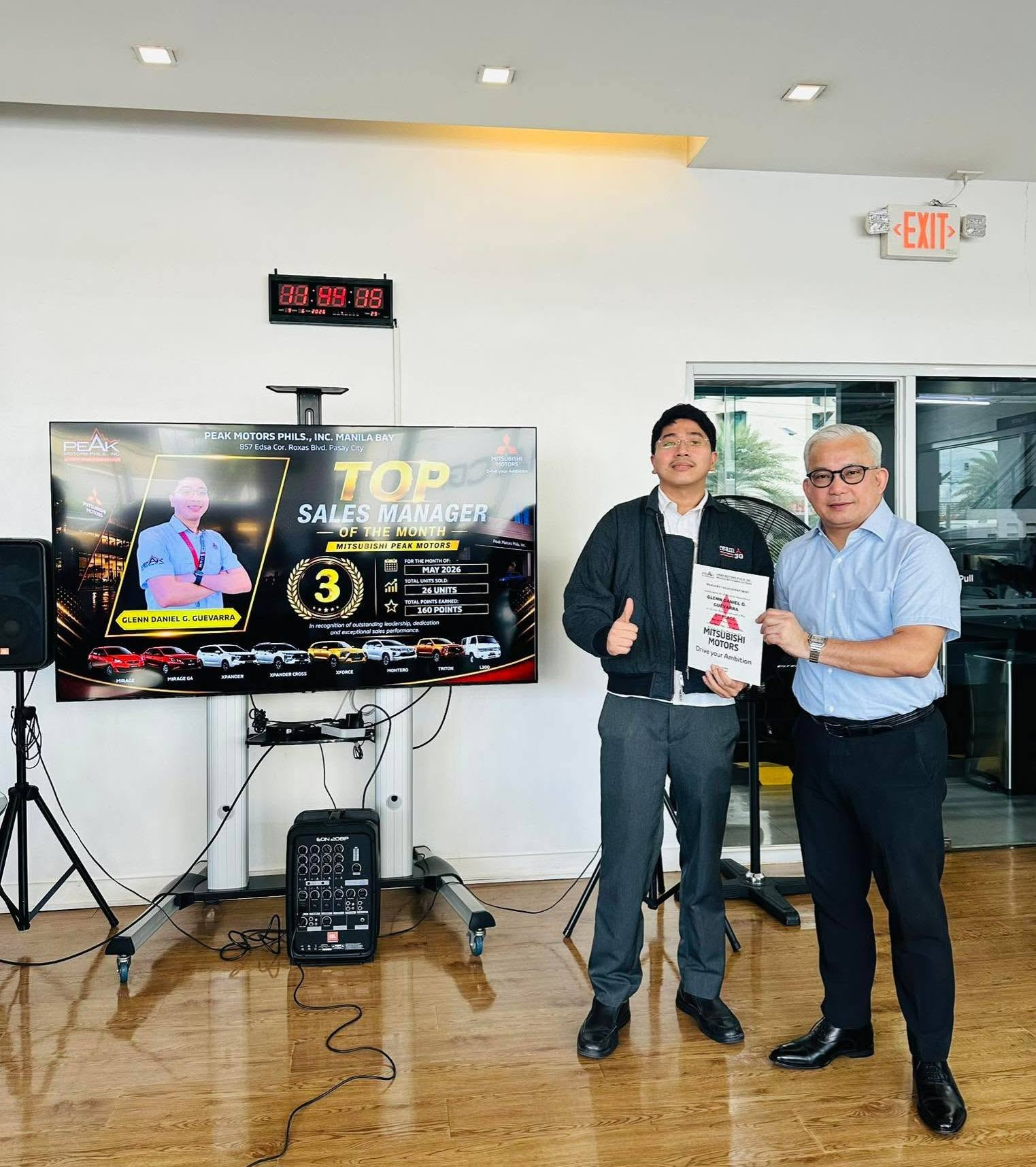 Glenn Guevarra with his Mitsubishi Motors sales recognition